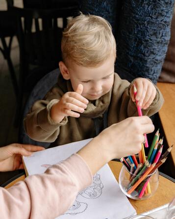 Child grabbing pencils